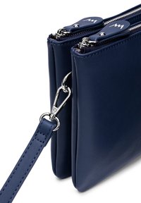 Navy blue leather handbag with dual zip compartments, silver hardware, and a detachable strap. Smooth texture and minimalist design.