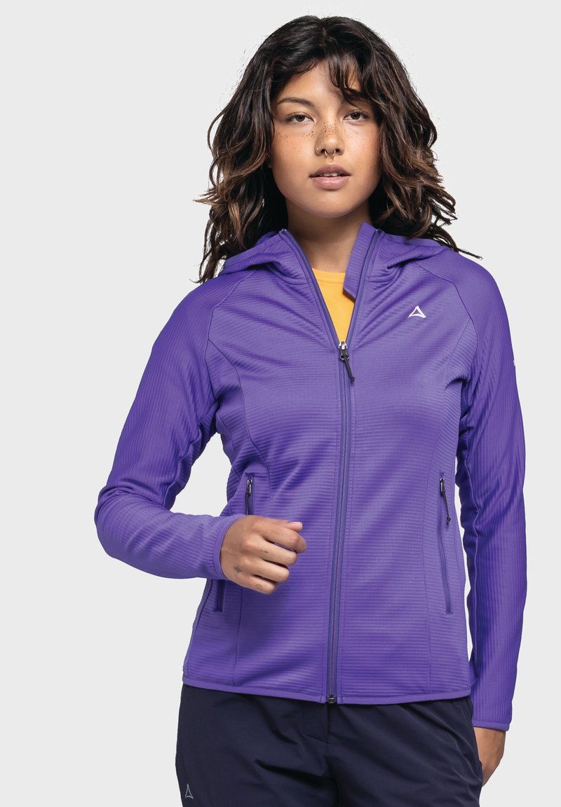 Lila Zip-Jacke mit strukturiertem Stoff, figurbetontem Schnitt und Kapuze. Verfügt über zwei Seitentaschen und ein kleines Logo auf der Brust.