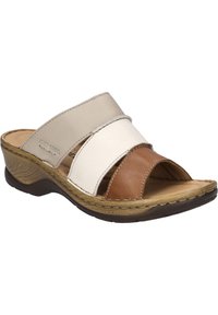 Brown, white, and beige leather slide sandals with three overlapping straps. Textured sole and low wedge heel. Casual open-toe design.