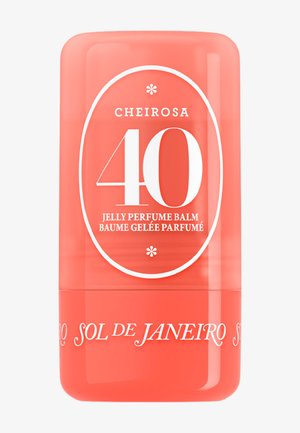 Stick bálsamo de perfume en gel color coral Sol de Janeiro Cheirosa 40 con texto blanco y diseño ovalado en la parte frontal.