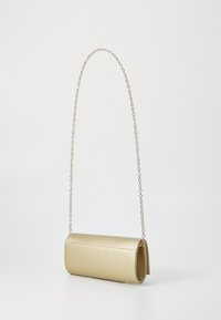 Metallic gold cylindrical handbag with a smooth texture, featuring a delicate chain strap and a zipper closure at one end.