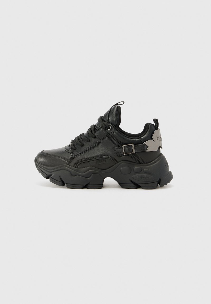 Black sneaker with synthetic leather upper, chunky rubber sole, rounded shape, lace-up design, and side buckle hardware detail.