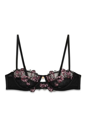 Černá průhledná podprsenka s kosticemi, růžovou květinovou krajkou a tenkými nastavitelnými ramínky.