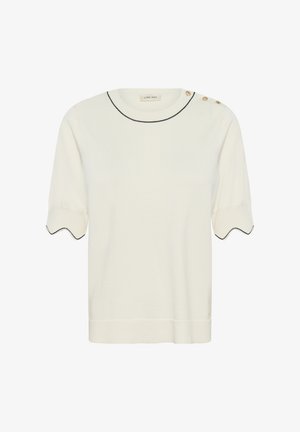 Haut en maille crème à manches courtes avec ourlets festonnés aux manches, bordure noire au niveau de l'encolure et des manches, et trois boutons dorés sur l'épaule gauche.