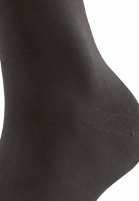 Schwarze Socke aus glattem, elastischem Stoff. Verfügt über eine nahtlose Zehenpartie und eine eng anliegende Form, mit matter Oberfläche und sauberen Kanten.