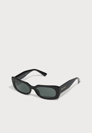 Black sunglasses with a rectangular frame, green lenses, and a shiny finish. Features gold branding on the temple. Textured detailing is absent.