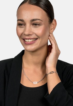 Silver chain necklace and bracelet set, featuring rectangular accents in a sleek design. Smooth texture with a polished finish.