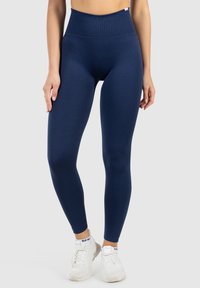 Marineblauwe high-waisted leggings van rekbaar materiaal, met een gladde textuur, aansluitend ontwerp en enkel-lange snit.