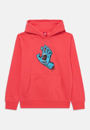 Korallgenser med frontlomme; har et blått grafisk motiv av en hånd med åpen munn, som fremhever sterke farger og en tegneserieaktig design.