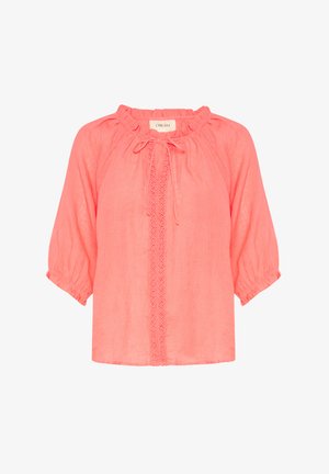 Blouse en lin corail avec des manches bouffantes, des poignets élastiques, un col froncé et des détails en dentelle décoratifs au centre. Texture douce et coupe décontractée.