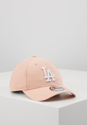 Light pink baseball cap with white "LA" logo embroidered on the front, placed on a white surface against a plain gray background.