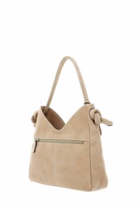Sac à main en cuir beige avec une anse nouée, une ouverture en forme de V et une poche zippée à l'avant. Texture douce et détails de couture visibles.