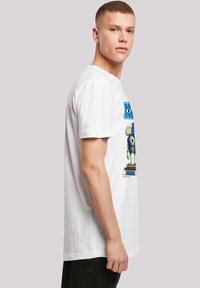 White cotton T-shirt featuring a colorful graphic of a character from Disney Pixar on the front, short sleeves, and a regular fit.