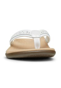 White flip-flop sandal with a textured, padded footbed, fabric strap featuring cut-out designs, and a flexible rubber outsole.