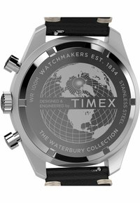 Stainless steel watch with black leather strap. Features a gray dial with a world map design and "Timex" branding. Water-resistant to 100m.
