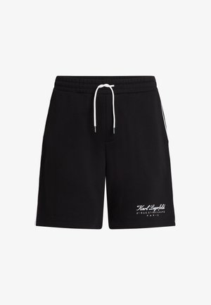 Mustad mustriga mustad puuvillase püksid elastse vöökoha ja valge nööriga. Alumises vasakus servas ja külgmistes triipudes on valge brändi logo tekst.