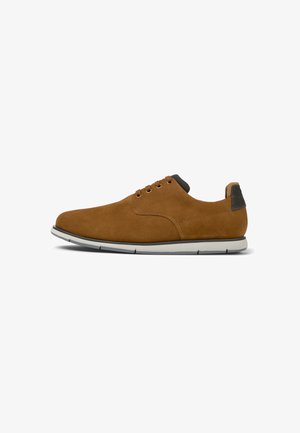 Brown suede lace-up shoes with a sleek design, featuring a white rubber sole and a textured heel accent. Light stitching detail.