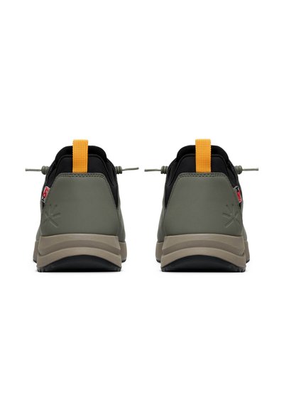 Green and black sneakers with a textured finish, featuring a yellow pull tab and a dual-tone sole. The design includes adjustable laces.