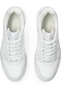 Scarpe sportive bianche realizzate in materiali in pelle e rete, con un design a taglio basso, punta rotonda e suola in gomma testurizzata. Chiusura con lacci.