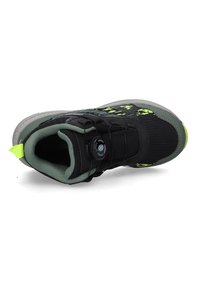 Schwarzer Sportschuh mit grünen Akzenten, ausgestattet mit einem strukturierten Obermaterial, einer runden Zehenpartie und einem sicheren Schnürsystem mit einem Drehverschluss.