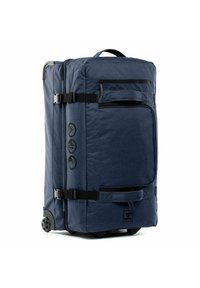 Rucksack mit Rollen, marinefarbener Stoff, rechteckige Form, mehrere mit Reißverschluss versehene Fächer, robuste schwarze Riemen und Räder für einen einfachen Transport.