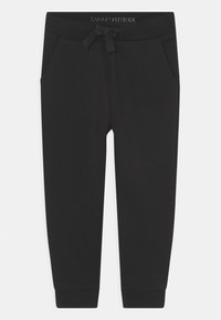 Schwarze Jogginghose mit einem Kordelzugbund, Seitentaschen, elastischen Knöchelabschlüssen und dem "SMARTGUESS"-Logo am Bund. Weicher Stoff.