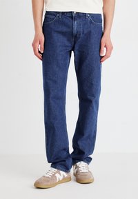 Mørkeblå denim jeans med en klassisk rette bein-design. Egenskaper inkluderer fem lommer, knappelukking og subtile sømdetaljer.