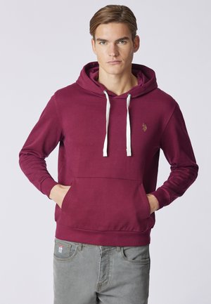 Felpa bordeaux in cotone, con tasca frontale, cordini e un piccolo logo sul petto. Texture liscia e vestibilità comoda.