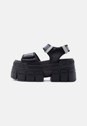 Black platform sandal with chunky sole, adjustable Velcro straps, and "Buffalo" branding along the midsole and heel.