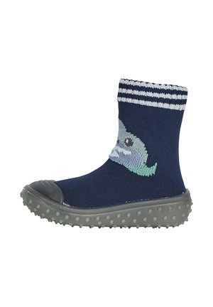 Navy ankle socks with a whale design, grey rubber sole, textured bobbles, and white striped cuff. Machine-knit fabric for comfort.