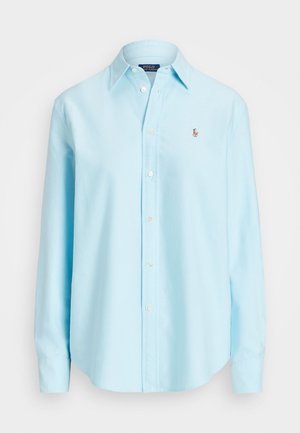 Light blue long-sleeve button-up shirt made of cotton, featuring a classic collar and a small embroidered logo on the chest.