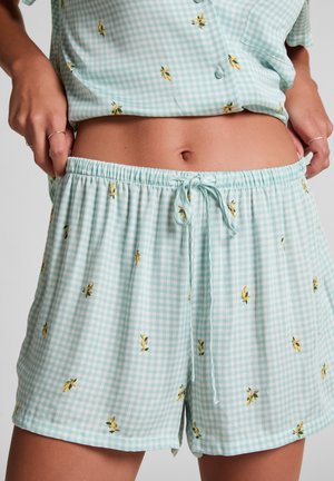 Light blue gingham shorts with yellow floral embroidery. Elastic waistband with drawstring for adjustment. Soft fabric and relaxed fit.