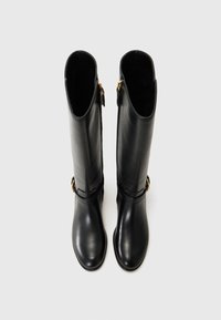 Black leather knee-high boots with a simple design, featuring a side zipper and a decorative gold buckle on the ankle strap.