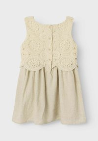Cremfarbendes Kleid mit einem Spitzen-Crochet-Oberteil und einem lockeren Leinenrock. Verfügt über Knöpfe und einen runden Ausschnitt. Mit strukturiertem Design durchgehend.