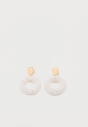 Gold stud earrings with circular clusters of small white beads forming a textured hoop hanging below each stud.