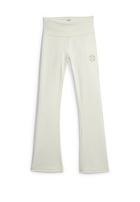 Leggings évasés couleur beige clair en tissu lisse et extensible, dotés d'une large ceinture et d'un petit logo sur la hanche.