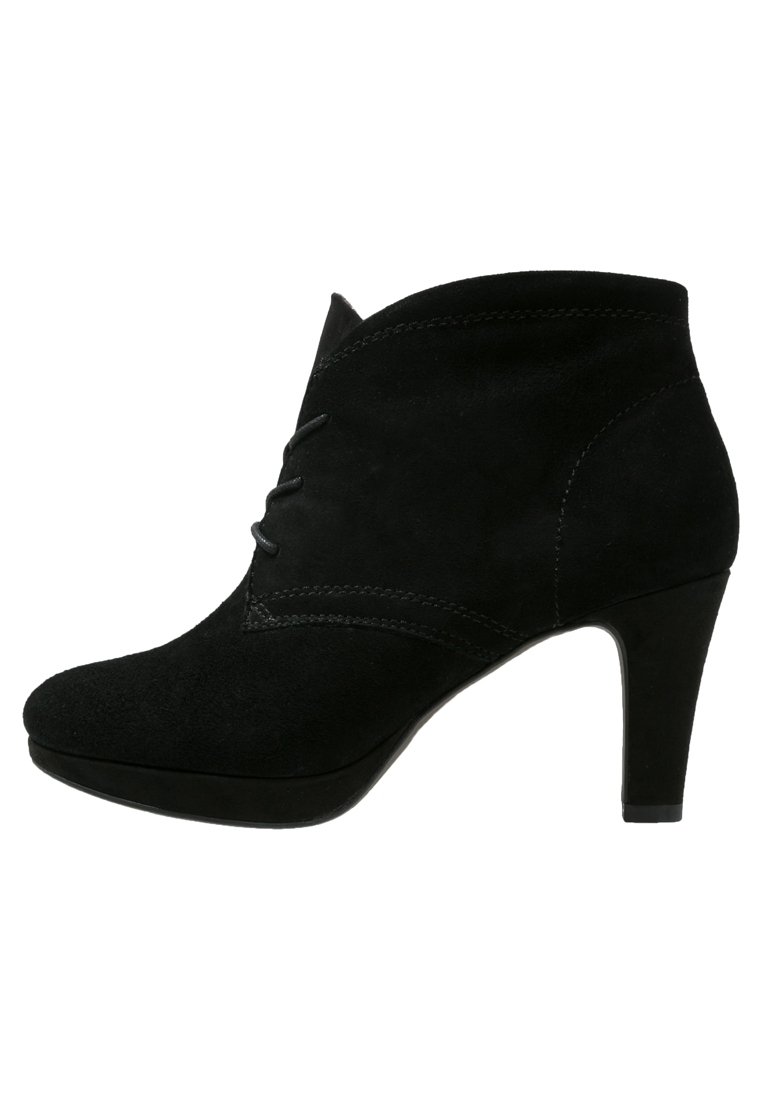 Botas de ante negras hasta el tobillo con punta afilada, línea superior curva y un tacón de 10 cm. Presentan costuras decorativas en la parte delantera.