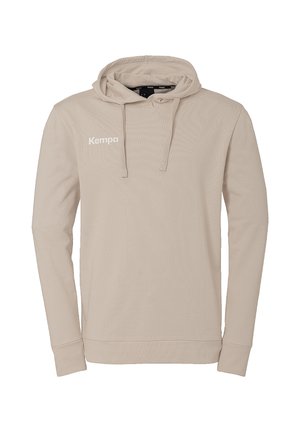 Beige hoodie met lange mouwen, trekkoorden en "Kempa" logo op de linkerborst, weergegeven op een effen witte achtergrond.