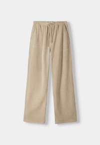 Pantalones de pana anchos color beige con textura estriada, cinturilla elástica y cordón ajustable. Cuenta con bolsillos laterales para mayor funcionalidad.