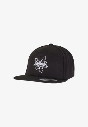 Black snapback hat with a flat brim, featuring a white embroidered logo in a graffiti style on the front. Made of textured fabric.