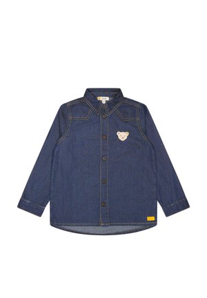 Długa koszula z ciemnoniebieskiego denimu z guziczkami z przodu, żółtym przeszyciem i małą naszywką z misiem na lewej piersi.