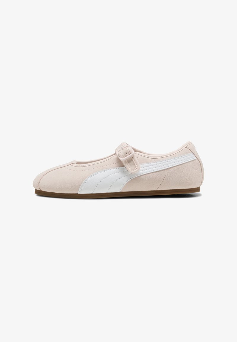 Light pink suede flat shoe with white side stripe, adjustable buckle strap, and brown sole, shown from left side on white background.