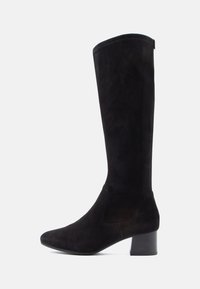 Knehøye svarte semskede støvler med rund tå og kraftig blokkhæl. Glatt tekstur med minimalt med detaljer og en enkel silhuett.