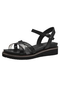 Sandales noires à lanières avec un mélange de surfaces mates et brillantes, dotées de découpes et d'une semelle texturée pour une meilleure adhérence. Bride de cheville ajustable.
