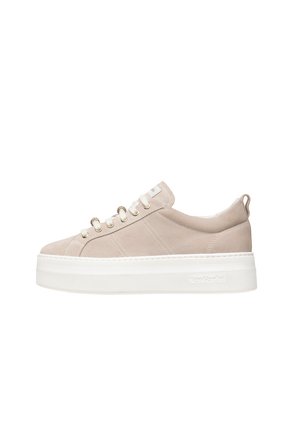 Beige suede sneaker with a thick white platform sole, featuring metal eyelets and a subtle logo on the side, smooth texture, and rounded toe.