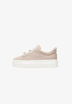 Beige suede sneaker with a thick white platform sole, featuring metal eyelets and a subtle logo on the side, smooth texture, and rounded toe.
