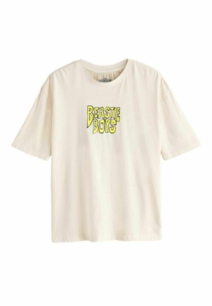 T-shirt a maniche corte color crema con scollo rotondo, con logo testuale giallo "BEASTIE BOYS" al centro del petto.