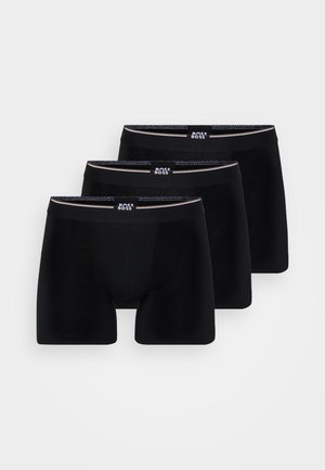 Mustast puuvillast bokserist aluspüksid, kolme komplekti. Omab elastset vööd logoga, sujuvat tekstuuri ja sobivat disaini. Ilma mustrite või aktsentideta.