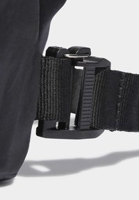 Black adjustable strap featuring a durable plastic buckle and textured webbing. The buckle is rectangular with a side release mechanism.