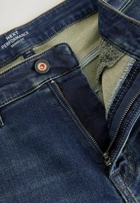 Škaprantsid tumedas sinises denimis. Omavad lukk-lendanud hõbedast riistvara, kontrastset sisefabrikat ja kerged kulumise detailid.